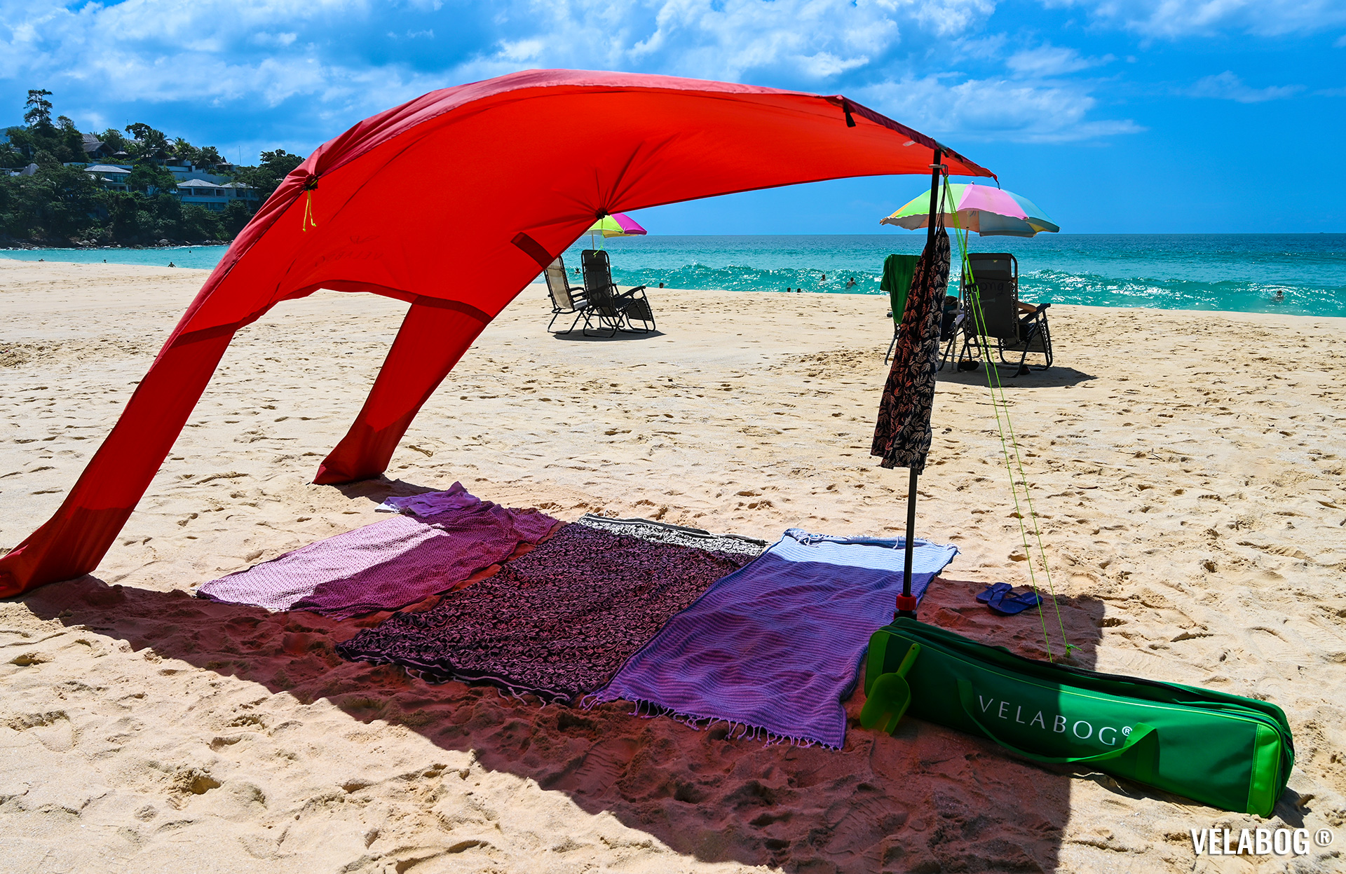 Beach sun sail Velabog Breeze, red. Best sun shelter on beach with a lot of shadow in comparison with beach umbrellas. Best beach canopy tent. Front view.