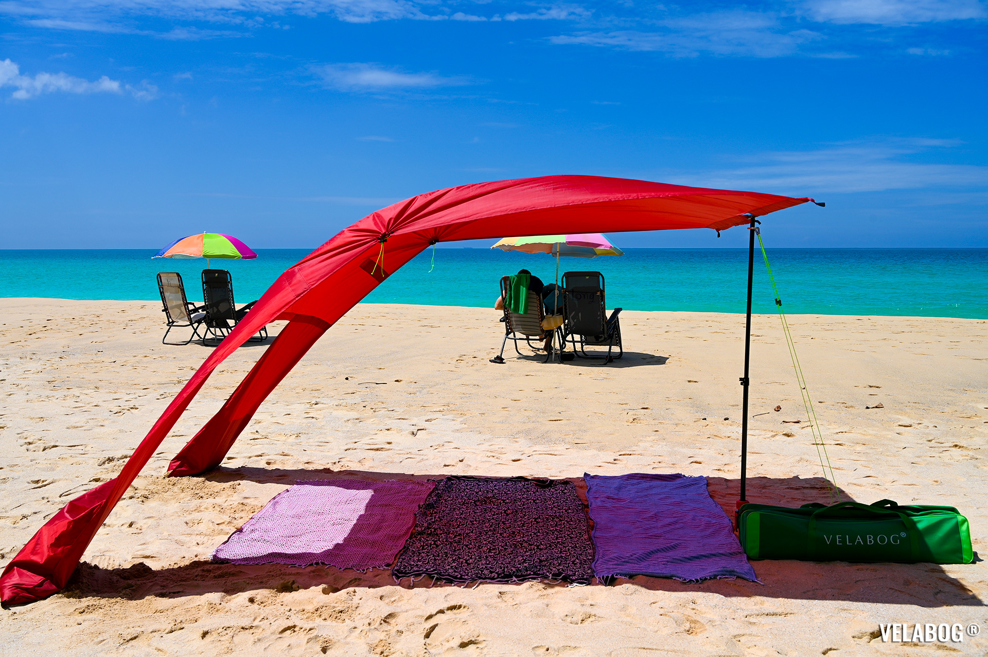 Beach sun sail Velabog Breeze, red. Best sun shelter on the beach. Best beach canopy tent. Setup option for light to strong wind. A lot more of shadow compared to beach umbrellas.